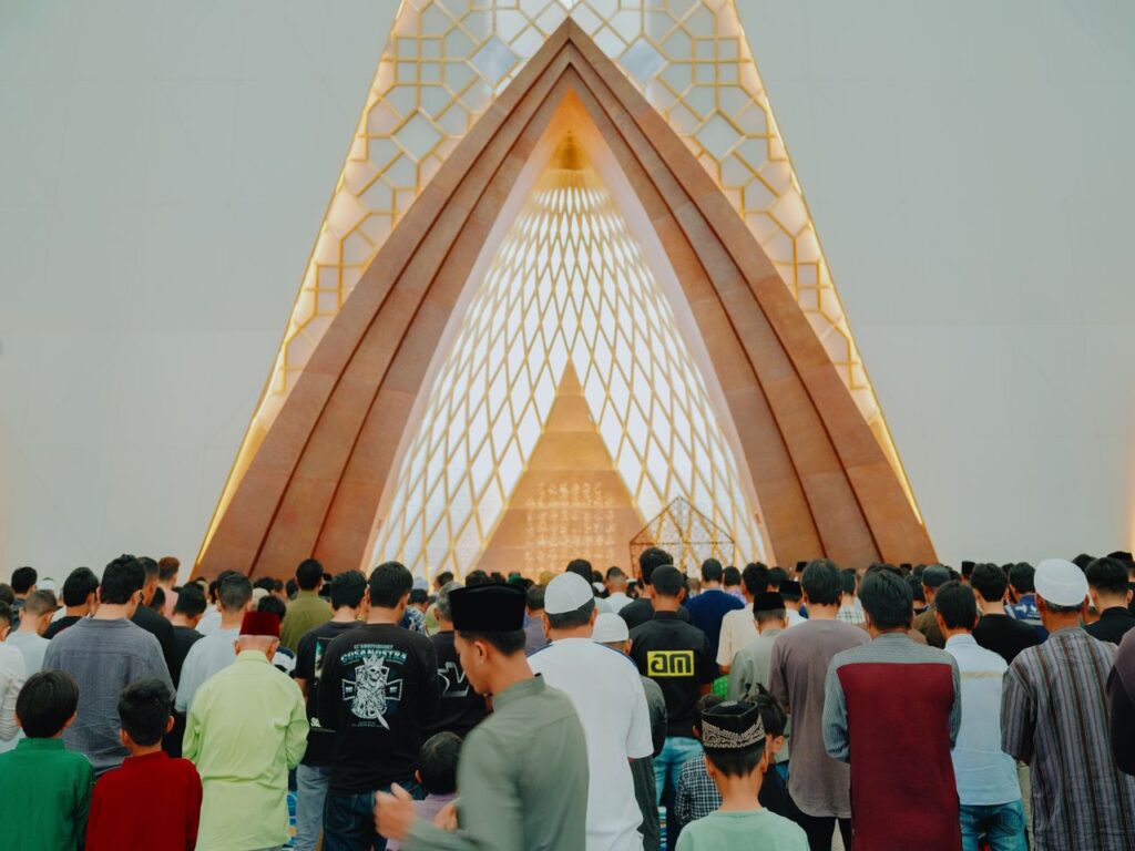 Hari Raya AidilFitri dan Hari Raya Haji:Perayaan Utama Umat Islam di Malaysia. A group of Muslims gathered for prayer inside a modern architectural mosque in Jawa Barat, Indonesia.